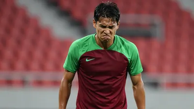 Mid-30s anonymous NEC midfielder, tense expression, clenched jaw, eyes narrowed in frustration, dark red and green...