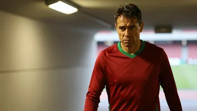 A 50-year-old Brazilian right-back, dressed in a plain, dark red and green polyester training top, his face set in a mix...